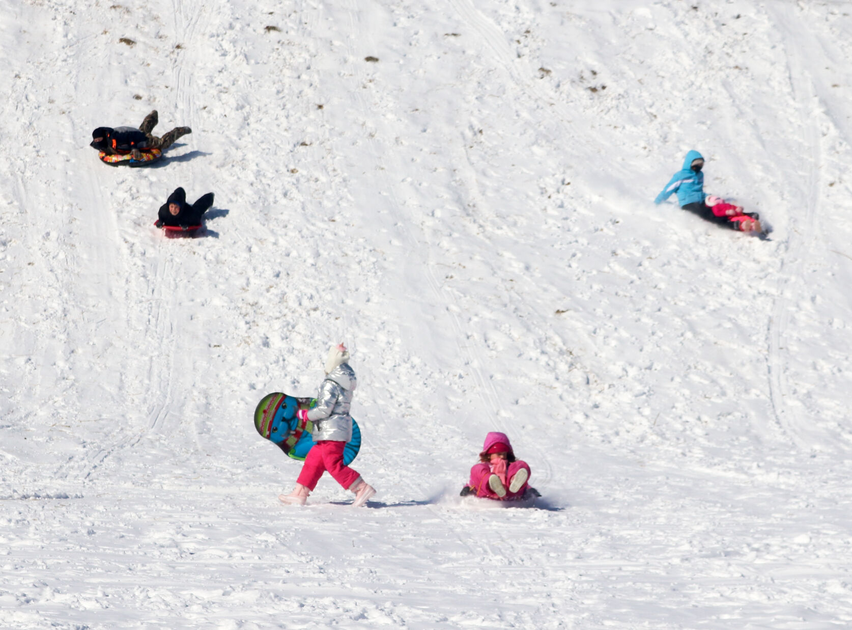 Anna Hatchett and Maddie McCullar land at the bottom of a hill